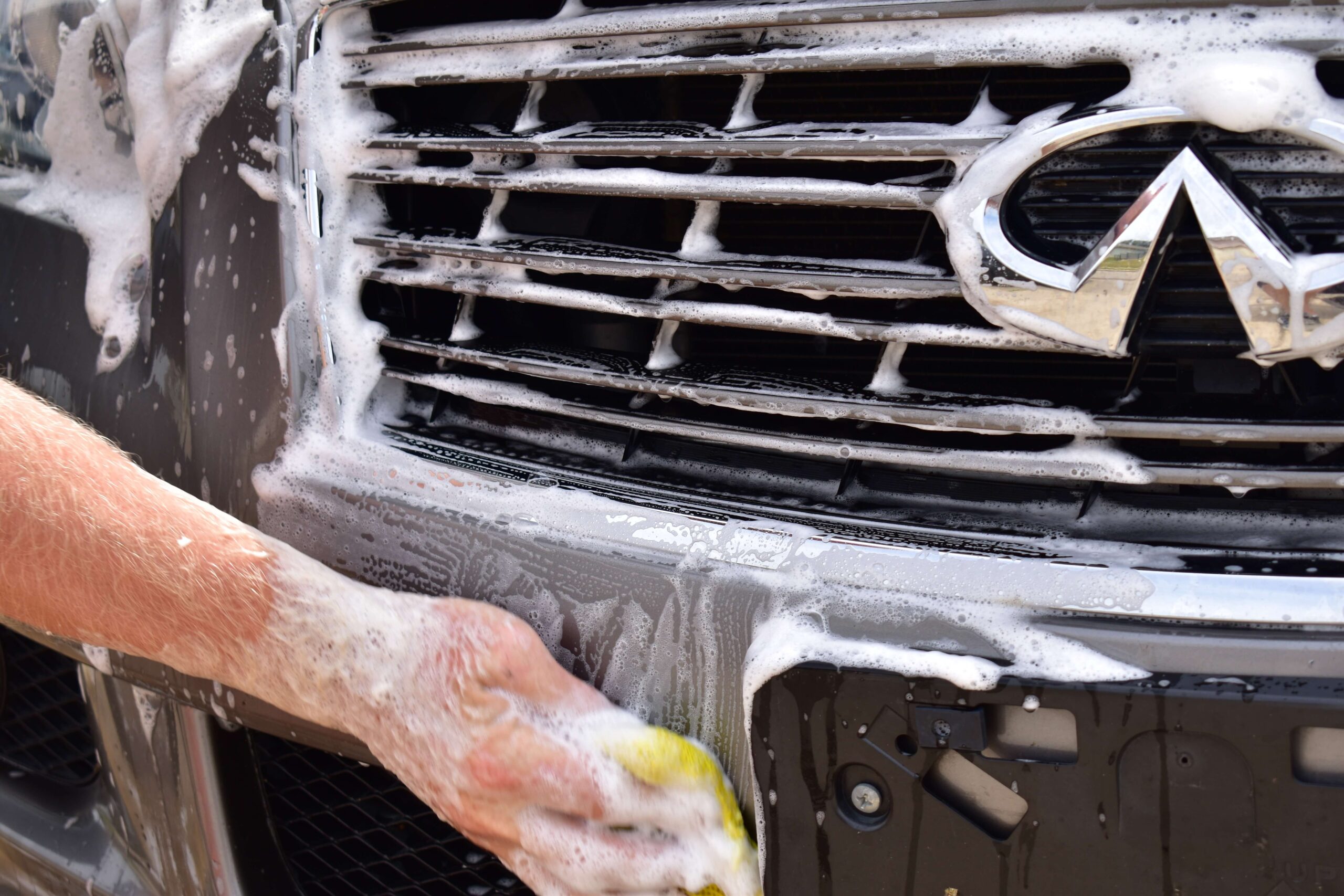Vehicle being hand-washed and waxed for paint protection