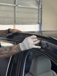 vinyl film being applied to chrome trim